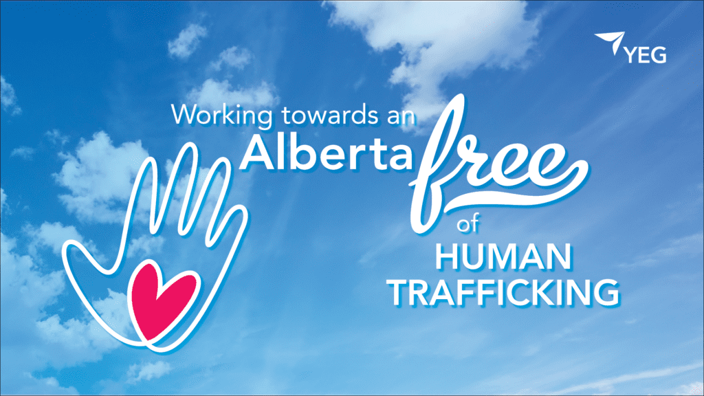 A graphic with a blue sky background and words that read Working towards an Alberta free of Human Trafficking. An outline of a hand with a heart in the center is on the left side of the graphic.